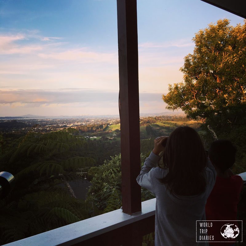 Two boys looking at the landscape with binoculars. Auckland is a great place to visit with kids - click for more!