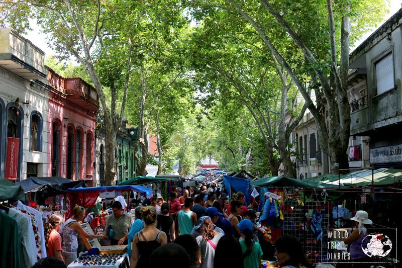 A very busy street lined with stalls and colonial houses in Montevideo, Uruguay. This street fair happens every weekend and it's endless!