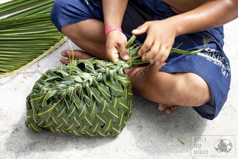 A man weaving a coconut tree leaf basket. They're very common in Samoa, just as anything woven from coconut tree leaves! Click for more!