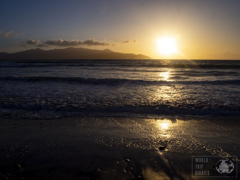 The sun setting over the sea of Castlegregory Beach, in Ireland. It's a lovely rocky beach with various water sports options. Click for more!