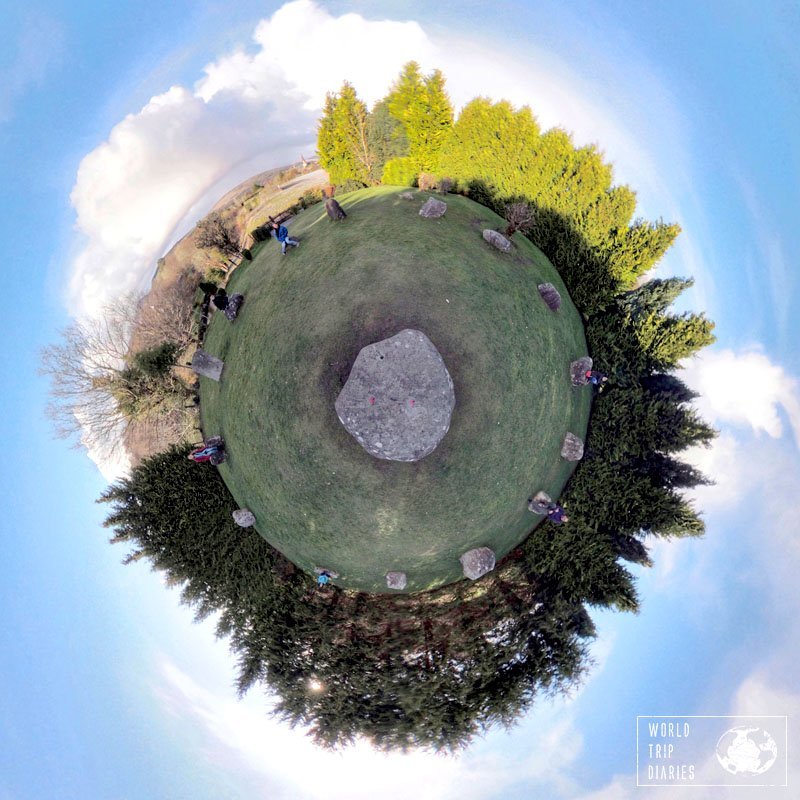 The Stone Circle of Kenmare, Ireland. A tiny planet, with trees on the edges, a large boulder in the middle, and 14 stores forming a circle around it. Click for more!